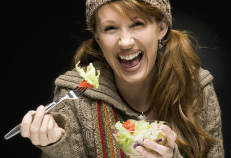 Woman Laughing Alone With Salad